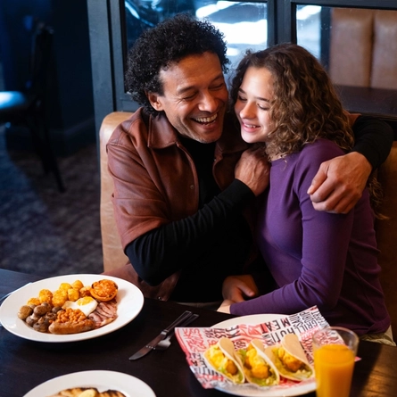 A family enjoying a meal and drinks in the interior restaurant from the new Spring/Summer menu at Flaming Grill.