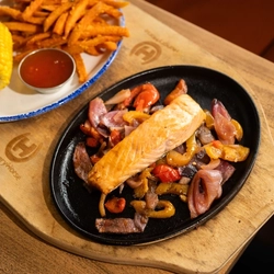 A served main of salmon sizzler available at Hungry Horse venues.