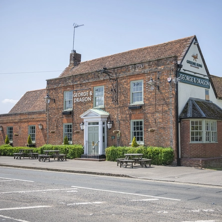 An exterior shot of the seating area & signage at the George & Dragon in Hazel Grove.