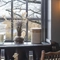 restaurant seating area with several different alcoholic drinks on the tables*