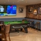 An interior games area at The Cherry Tree in Newcastle-Under-Lyme; with a pool table, a TV on the wall, and restaurant seating.