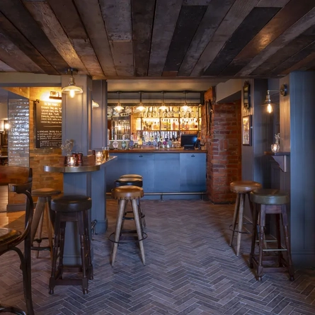 Bar area with high stools and glasses on the table