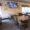 Interior dining area of a pub with a TV.