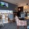 The interior restaurant and seating area with TV and dart board at The Woodlands.