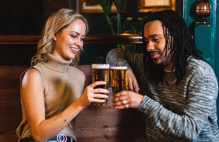 Two people having a pint in the pub