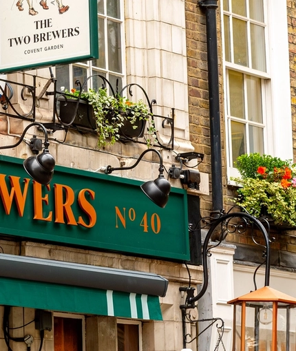 A close up view of the exterior facade and signage of The Two Brewers in Covent Garden.