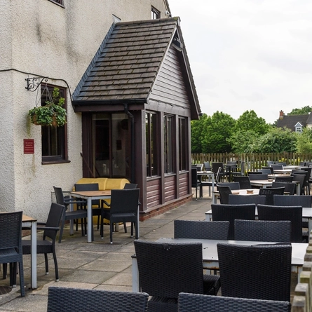 Exterior beer garden of a pub with a seating area.