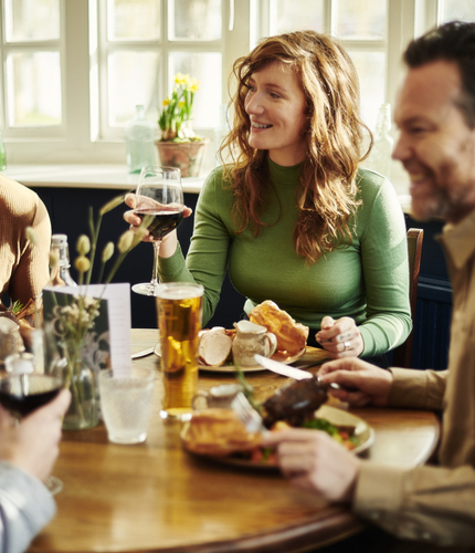 A group of people enjoying a roast dinner.