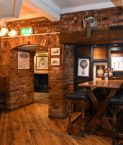 Interior dining area of a pub with a TV.