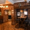 Interior dining area of a pub with a TV.