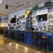 Interior dining area of a pub with TVs and a bar.
