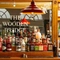 A close up view of bottles of spirits on a wooden shelf at the bar inside the Wooden Bridge.