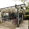 Exterior beer garden of a pub with a gazebo, a seating area and a TV.