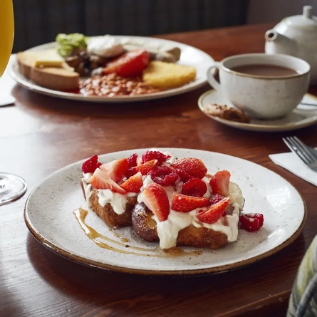 A plate of french toast on a table.