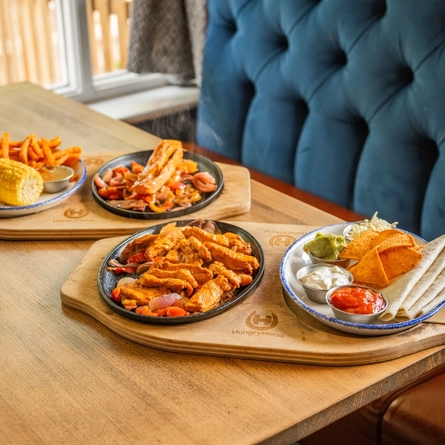 Served main dishes of fajitas and salmon available on the Hungry Horse Autumn Winter menu.