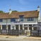 The exterior facade, signage and seating area at The Good Intent in Hornchurch.