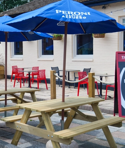 The exterior signage and beer garden seating area at The Peregrine.