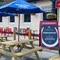 The exterior signage and beer garden seating area at The Peregrine.