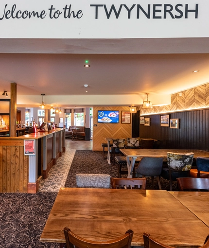 Interior dining area of a pub with a bar.