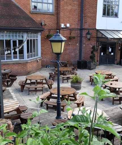 Exterior beer garden of a pub with a seating area.