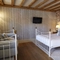 interior room of a hotel with a double bed, a sofa and a TV