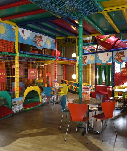 Interior kids play area and a seating area of a pub.