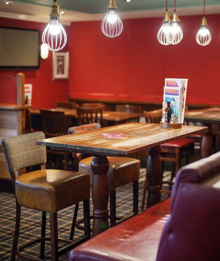 Interior dining area of a pub with a TV.