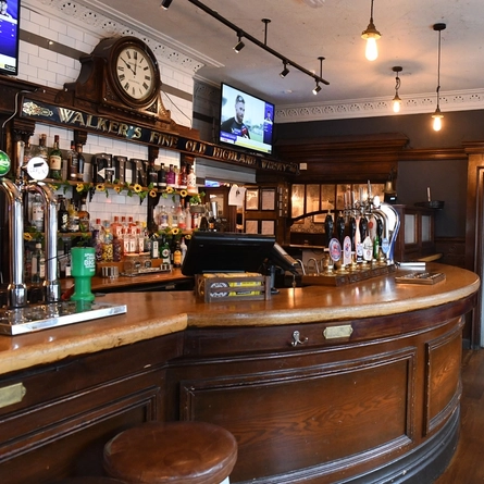 Interior dining area of a pub with a bar.