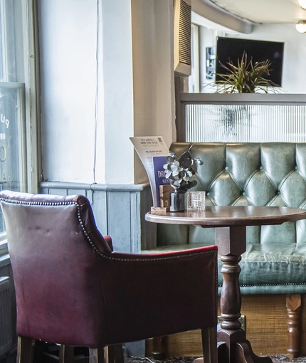 The interior restaurant seating area and TV at The Bull.