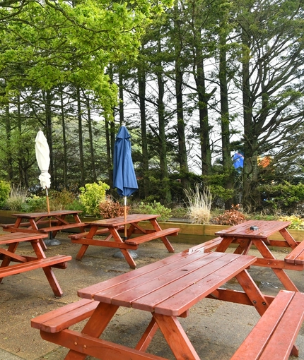 Exterior beer garden of a pub with a seating area.