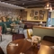 The interior restaurant and seating area with fireplace at The Bell.