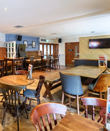 Interior dining area of a pub with a TV.