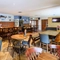 Interior dining area of a pub with a TV.