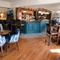 The interior bar and restaurant seating area with electronic pub game at The Yorkshire Grey.