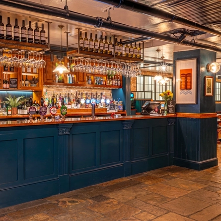 The wood panelled bar and interior restaurant seating area of the Monument in Whitechapel.