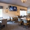 Interior dining area of a pub with a TV.