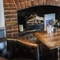 The interior restaurant seating area with feature fireplace and two chalkboards at The Bull.