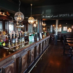 The interior bar and seating area with fireplace at The Starbank Inn.