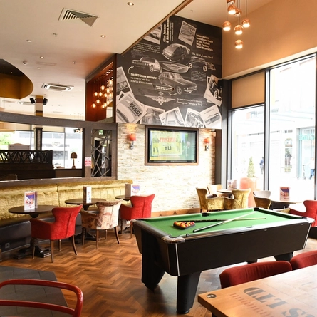The interior restaurant seating area with TV and pool table at The Interceptor.