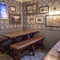 Interior decor featuring patterned wallpaper, framed artwork, and a bench.