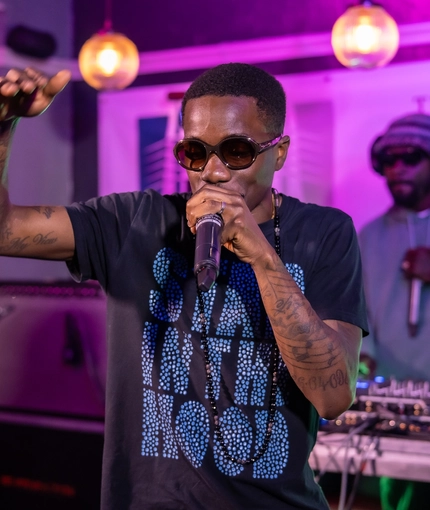 An interior image of a live music act stood on a stage performing during The Boat Race event at The Crabtree.