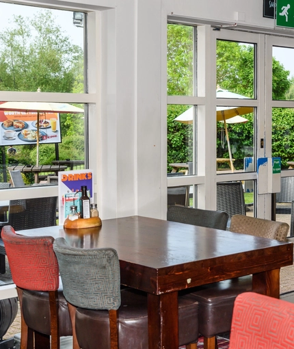 Interior dining area of a pub with a TV.