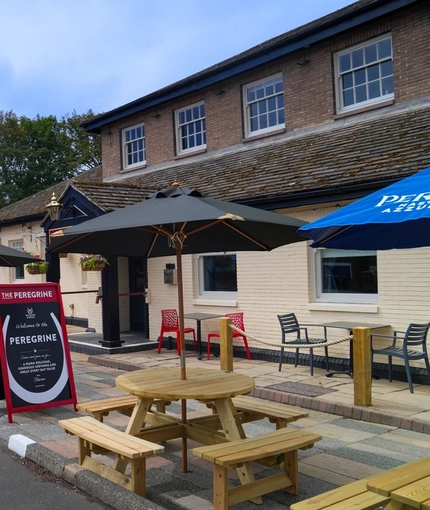 The exterior facade and beer garden seating area of The Peregrine in Newcastle-Upon-Tyne.