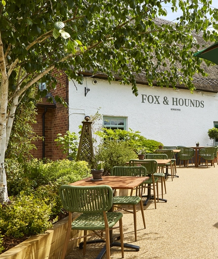The exterior facade and beer garden seating area at The Fox & Hounds in Wimborne.
