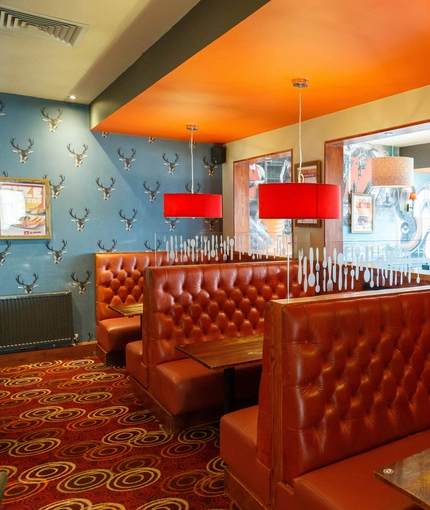 Interior dining area of a pub with a TV.