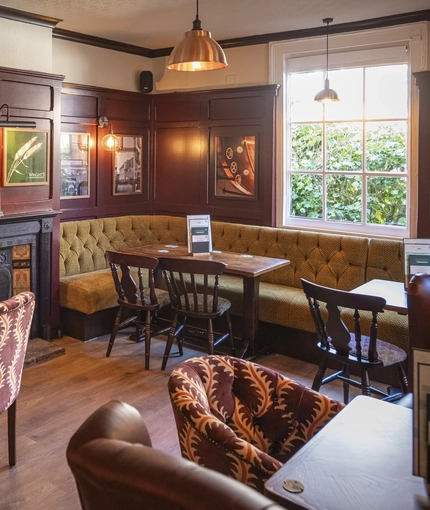 The interior restaurant seating area with feature fireplace at The Crown & Horseshoes.