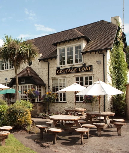 exterior facade of a pub with a seating area