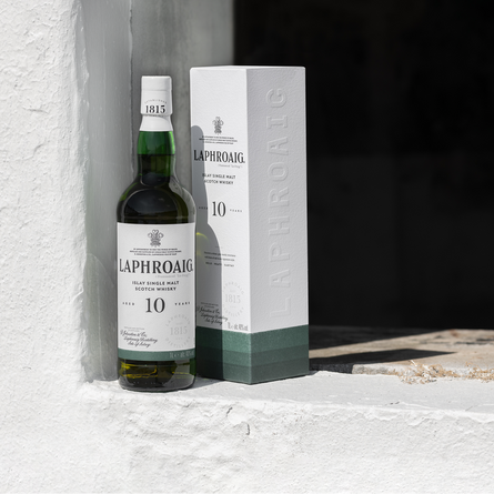 An advertising image featuring a bottle of Laphroaig Whisky next to a branded box for Belhaven.