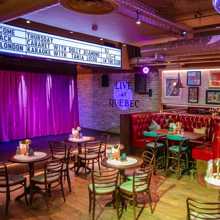 The interior restaurant and seating area with live event stage at The City Of Quebec.
