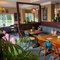 The interior restaurant seating area with tables, chairs, cushioned seating and hanging pendant lighting at The Church View Inn.
